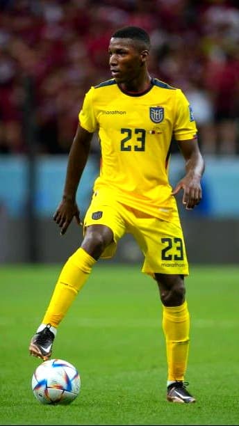 A soccer player in a yellow Ecuador national team uniform with the number 23 controls a ball on the field during a match, streamed live on Bulgaria IPTV. The background shows blurred spectators in a stadium.