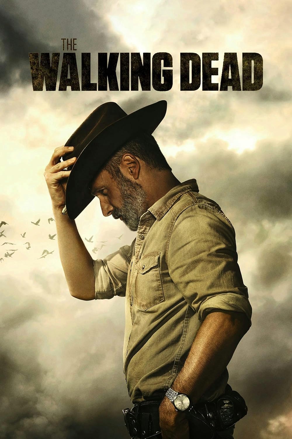 A man in a sheriff’s outfit tips his hat beneath a dramatic, cloudy sky with birds flying overhead. “The Walking Dead” appears at the top—perfect for streaming on Bulgaria IPTV.